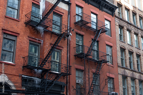 Row of Beautiful Old Brick Buildings with Ice and Fire Escapes in NoHo of New York City during the Winter
