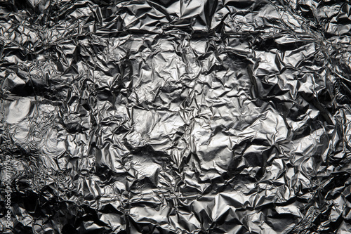 Silver crumpled aluminum texture closeup