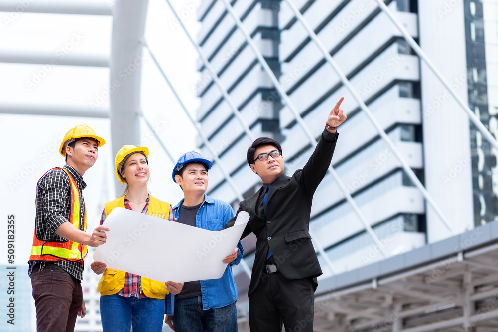 success female and male engineer discuss and manage work together with blueprint and wear safety hat at technology construction site success female and male engineer discuss and manage work together with blueprint and wear safety hat at technology construction site