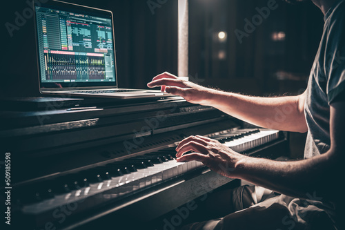 Bild auf Leinwand A man composer, producer, arranger, songwriter, musician hands arranging music