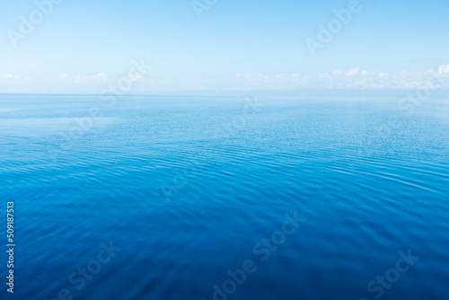 Blue sea water. Water and sky. Natural ocean surface background on the sky.