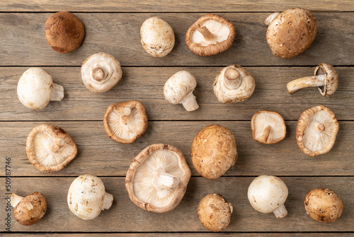 Shimeji, portobello and paris mushrooms over wooden table