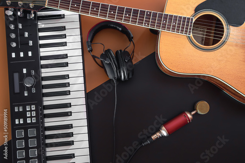 Flat lay, music background with acoustic guitar and piano.