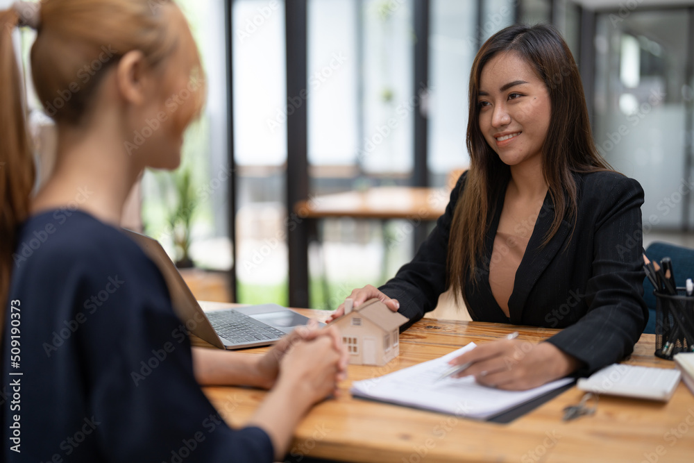 Real estate agent offer hand for customer sign agreement contract signature for buy or sell house. Real estate concept contact agreement concept Real estate agent offer hand for customer sign agreement contract signature for buy or sell house. Real estate concept contact agreement concept