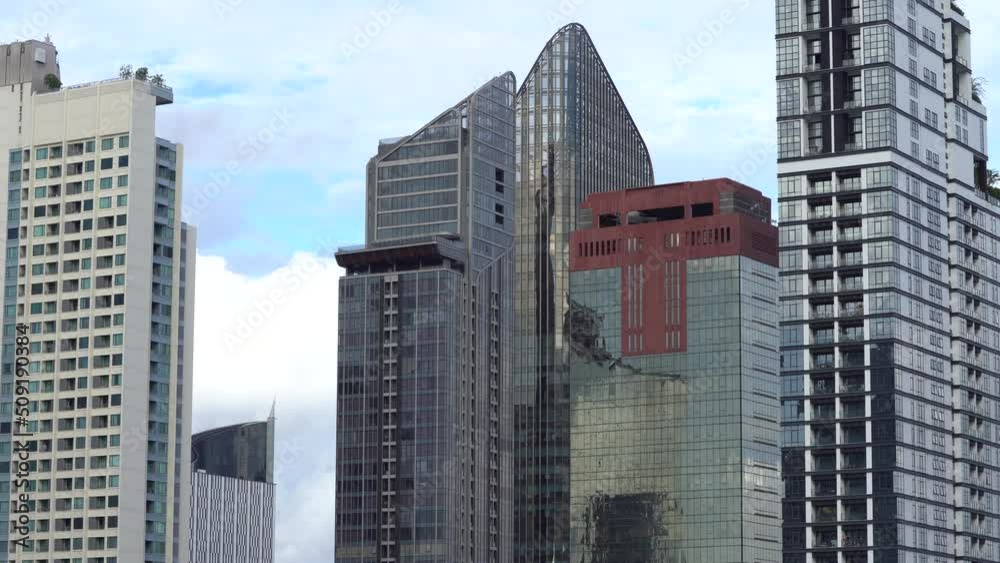 Clouds In Motion Behind Skyscraper and reflection of Skyscraper windows - Static