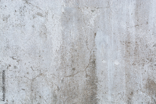 The background of an old concrete wall painted white with cracks. The texture of the plaster. © Aigul