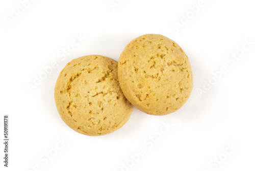 Two round oatmeal cookies for a baby close-up on a white isolated background.