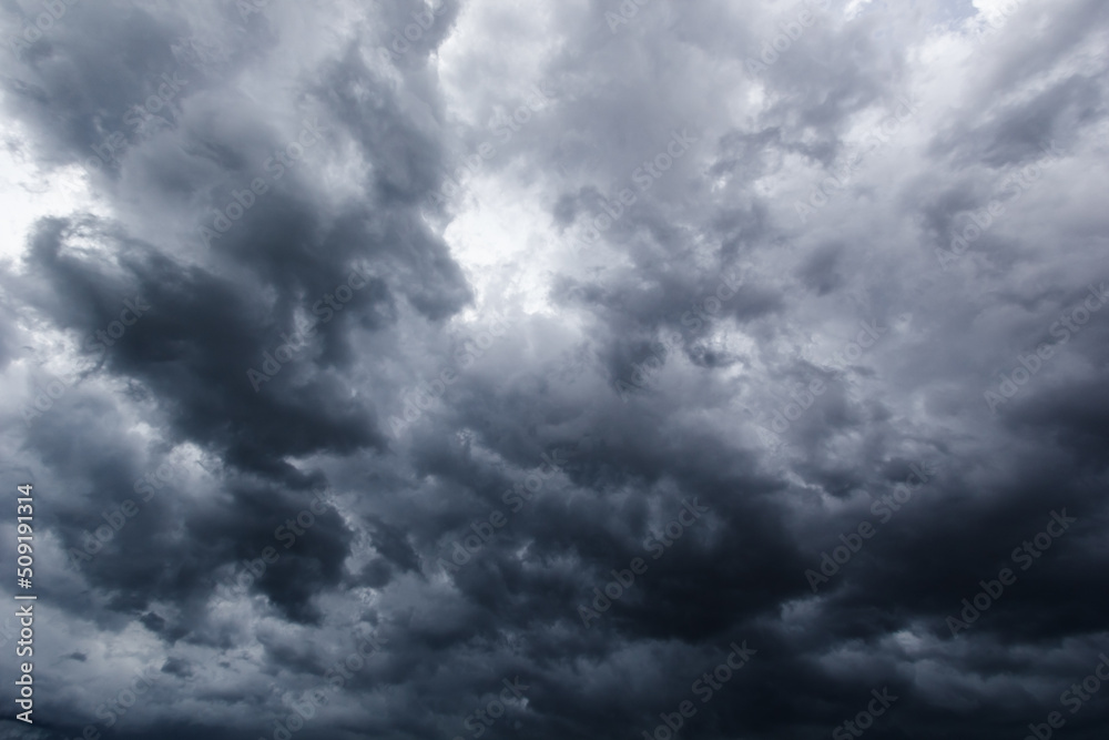 The dark sky with heavy clouds converging and a violent storm before the rain.Bad or moody weather sky.. The dark sky with heavy clouds converging and a violent storm before the rain.Bad or moody weather sky..