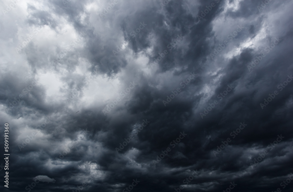 The dark sky with heavy clouds converging and a violent storm before the rain.Bad or moody weather sky. The dark sky with heavy clouds converging and a violent storm before the rain.Bad or moody weather sky.