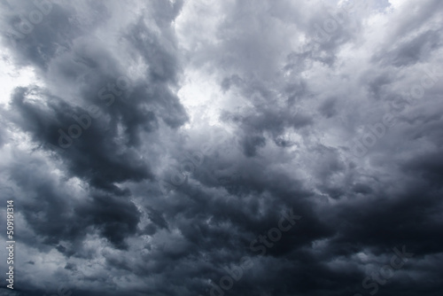 Fototapeta Naklejka Na Ścianę i Meble -  The dark sky with heavy clouds converging and a violent storm before the rain.Bad or moody weather sky..