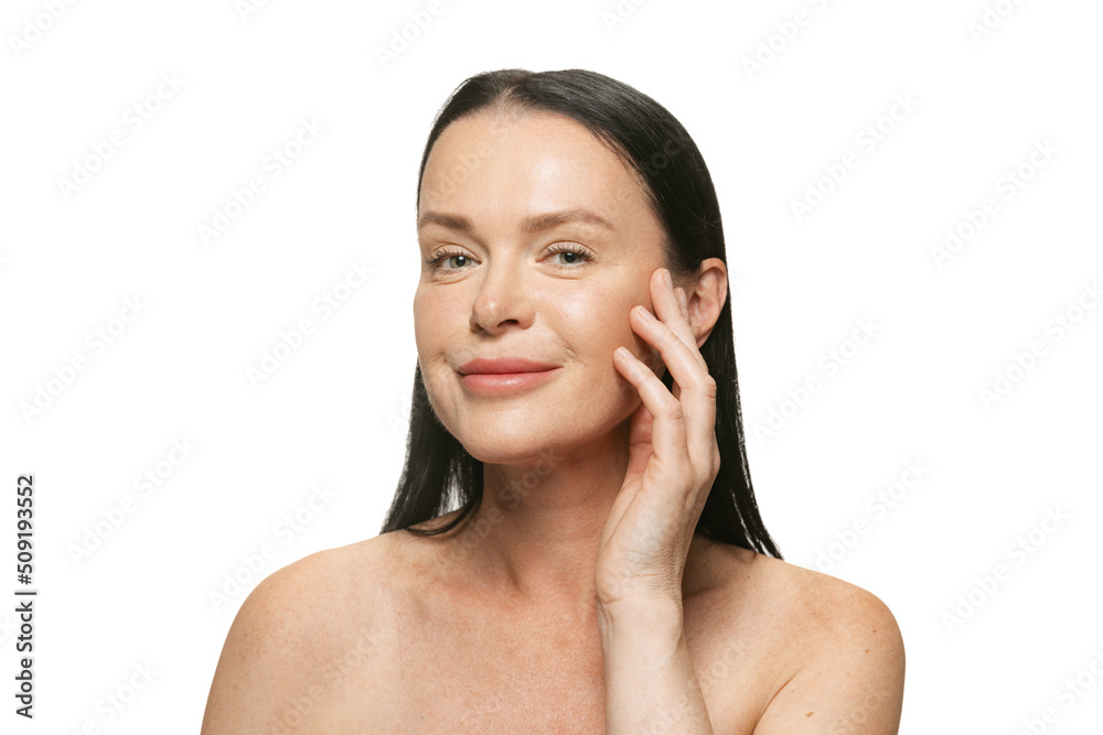 Close-up portrait of middle age, 44 years old beautiful woman with long black hair on white background. Beauty, spa, age-related changes, face lifting and skin care concept Close-up portrait of middle age, 44 years old beautiful woman with long black hair on white background. Beauty, spa, age-related changes, face lifting and skin care concept