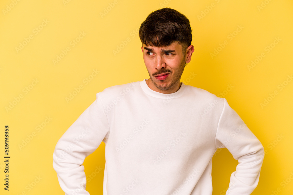 Young caucasian man isolated on yellow background confused, feels doubtful and unsure. Young caucasian man isolated on yellow background confused, feels doubtful and unsure.