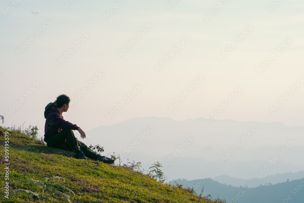 hiker man relax with wellbeing and happy feeling on top of mountain