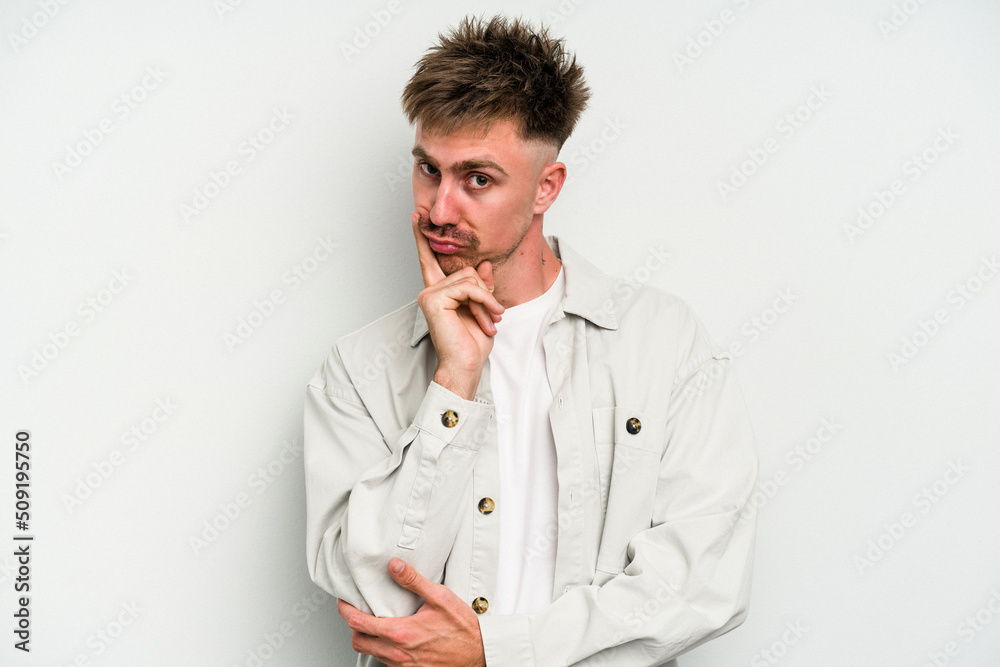 Young caucasian man isolated on white background contemplating, planning a strategy, thinking about the way of a business. Young caucasian man isolated on white background contemplating, planning a strategy, thinking about the way of a business.