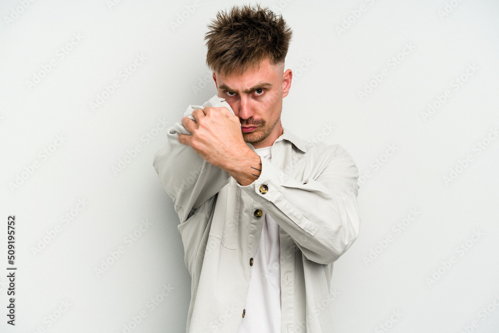 Young caucasian man isolated on white background having a neck pain due to stress, massaging and touching it with hand. Young caucasian man isolated on white background having a neck pain due to stress, massaging and touching it with hand.