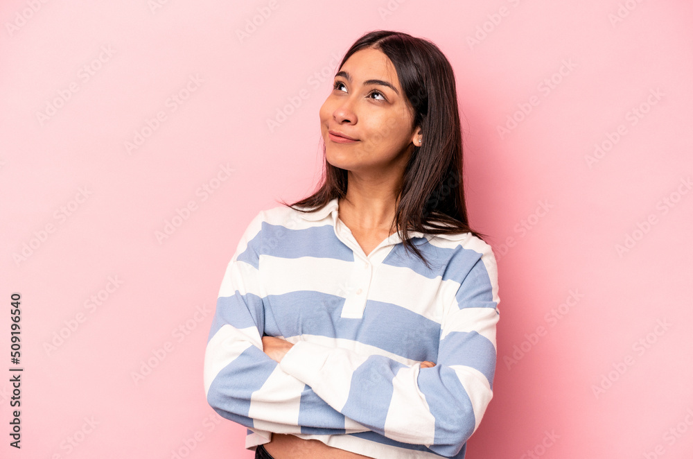 Young hispanic woman isolated on pink background dreaming of achieving goals and purposes Young hispanic woman isolated on pink background dreaming of achieving goals and purposes