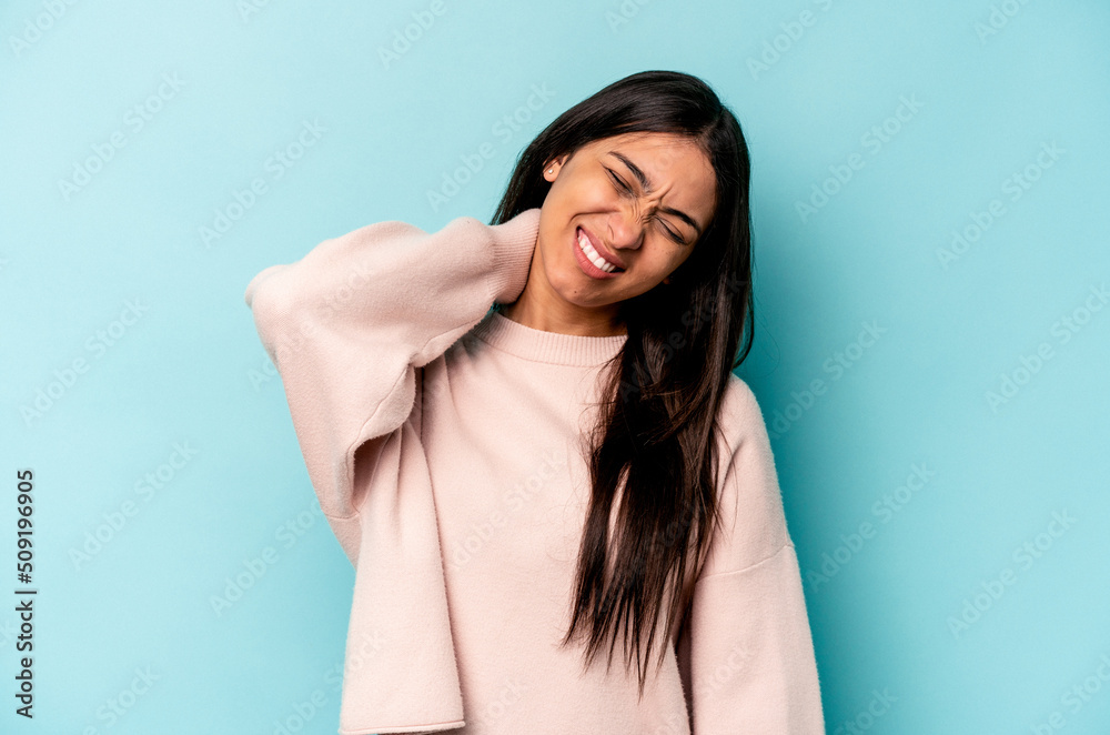 Young hispanic woman isolated on blue background suffering neck pain due to sedentary lifestyle. Young hispanic woman isolated on blue background suffering neck pain due to sedentary lifestyle.