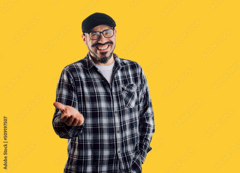 Friendly and smiling man looks at camera with outstretched hand Friendly and smiling man looks at camera with outstretched hand