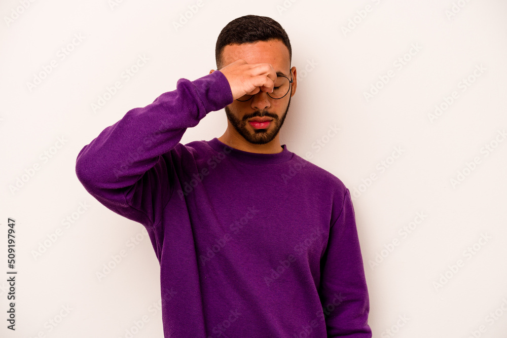 Young hispanic man isolated on white background having a head ache, touching front of the face.