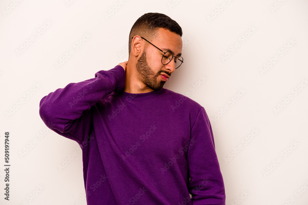 Young hispanic man isolated on white background having a neck pain due to stress, massaging and touching it with hand.