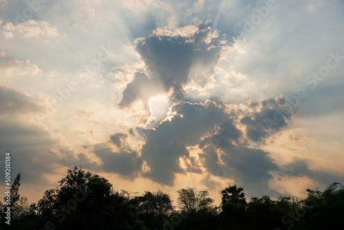 Beautiful cloudscape on sky with large  building clouds and sunset breaking through cloud mass nature background.