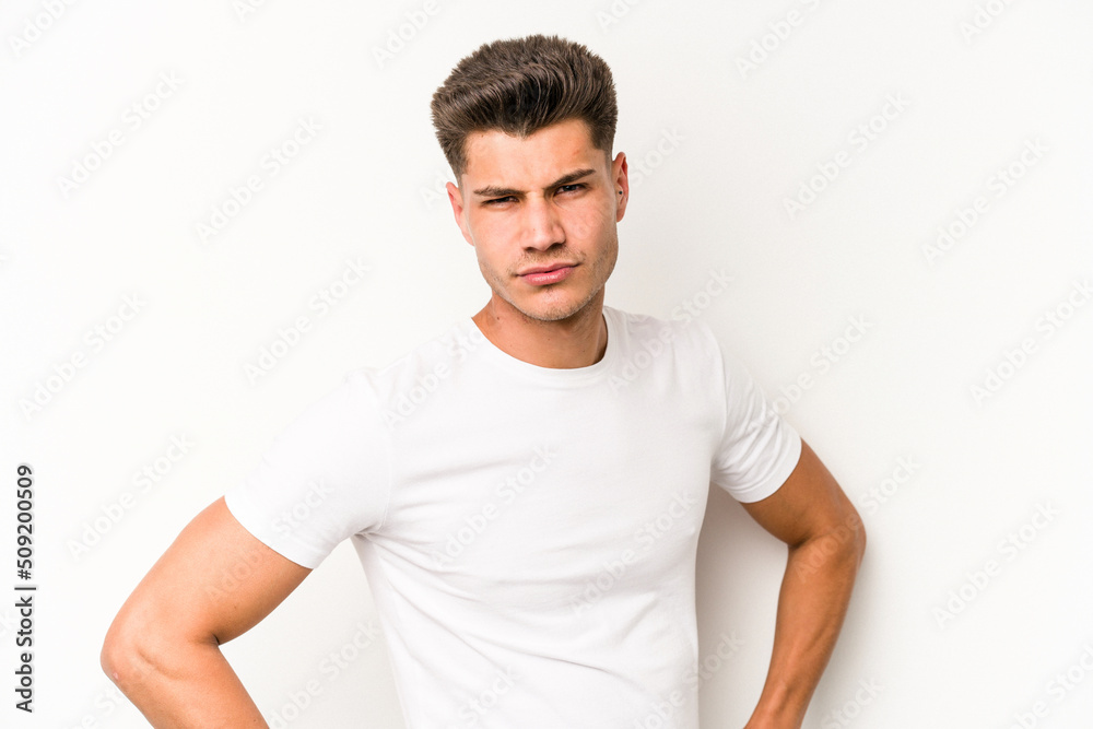 Young caucasian man isolated on white background frowning face in displeasure, keeps arms folded. Young caucasian man isolated on white background frowning face in displeasure, keeps arms folded.