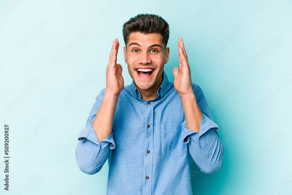 Young caucasian man isolated on blue background laughs out loudly keeping hand on chest. Young caucasian man isolated on blue background laughs out loudly keeping hand on chest.
