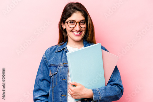 Young student caucasian woman isolated on pink background happy, smiling and cheerful.