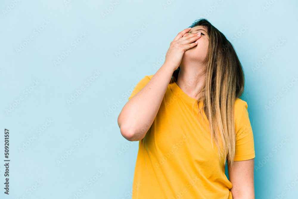 Young caucasian woman isolated on blue background laughing happy, carefree, natural emotion. Young caucasian woman isolated on blue background laughing happy, carefree, natural emotion.