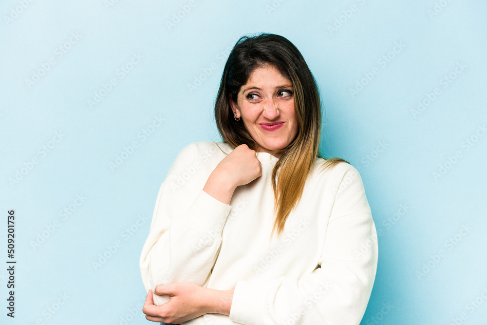 Young caucasian woman isolated on blue background confused, feels doubtful and unsure. Young caucasian woman isolated on blue background confused, feels doubtful and unsure.