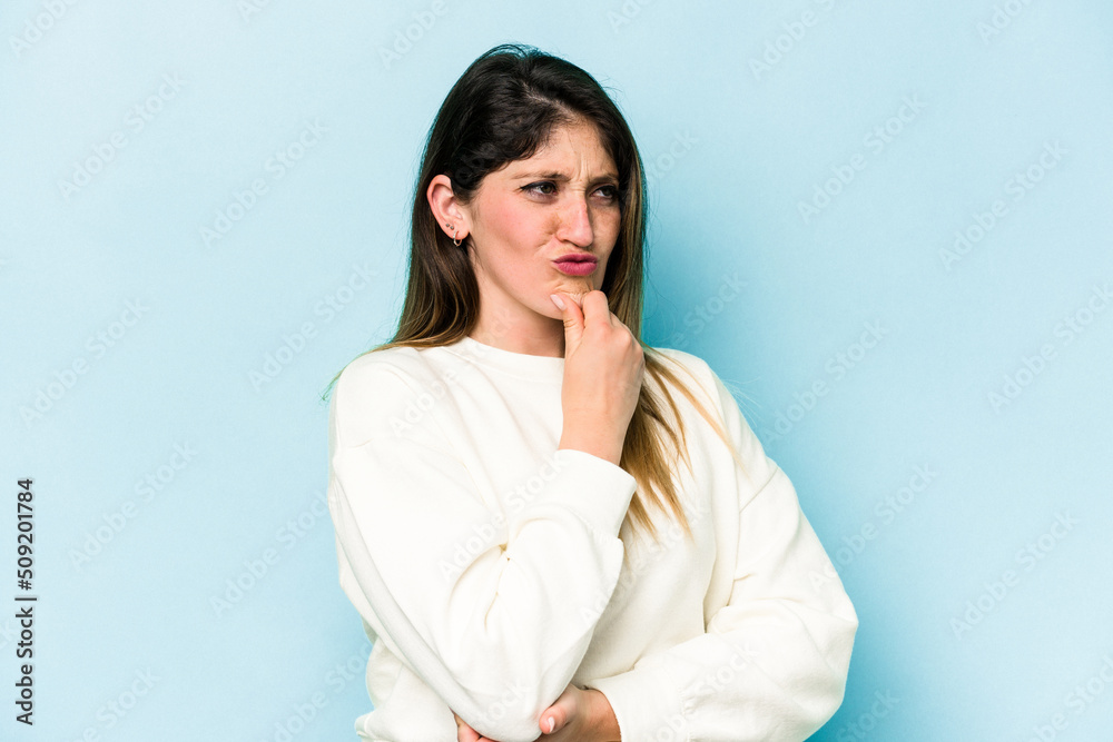 Young caucasian woman isolated on blue background suffers pain in throat due a virus or infection. Young caucasian woman isolated on blue background suffers pain in throat due a virus or infection.