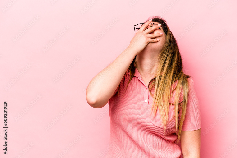 Young caucasian woman isolated on pink background laughing happy, carefree, natural emotion. Young caucasian woman isolated on pink background laughing happy, carefree, natural emotion.