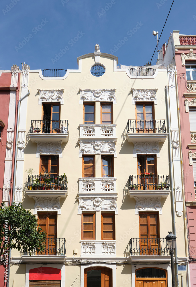 Naklejka premium Facade of a beautiful apartment with wooden windows and balconies.