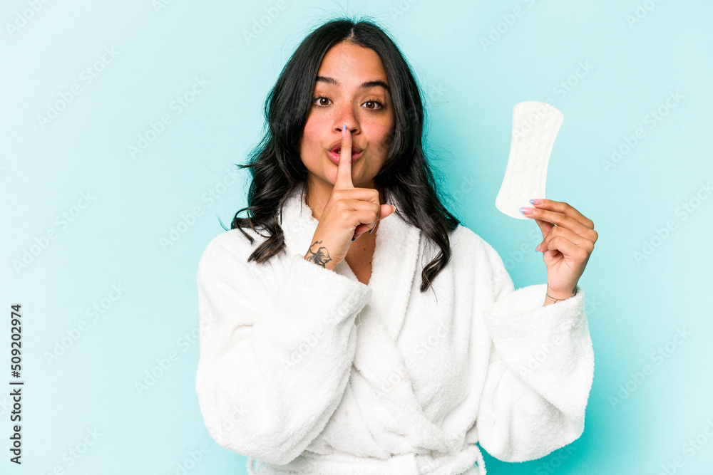 Young caucasian woman holding sanitary napkin isolated on pink background keeping a secret or asking for silence. Young caucasian woman holding sanitary napkin isolated on pink background keeping a secret or asking for silence.