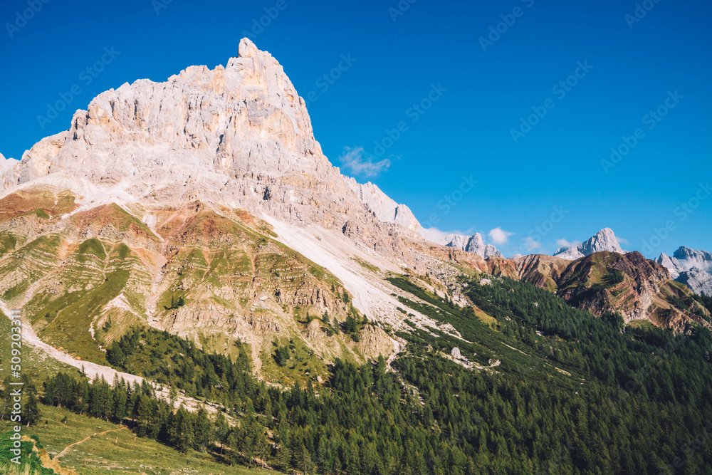 Scenery nature landscape of mountains surrounded by green meadows. Peaceful atmosphere and ideal environment for relaxation. Beautiful Dolomites on background