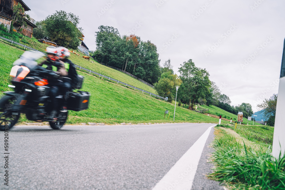 Motorcycle rides a serpentine in a beautiful mountainous area, motion blur effect. Motorcycle trip in Europe