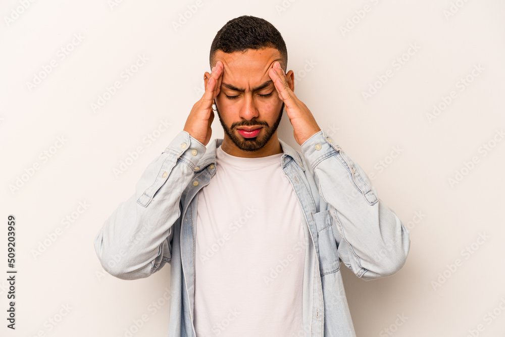 Young hispanic man isolated on white background having a head ache, touching front of the face. Young hispanic man isolated on white background having a head ache, touching front of the face.