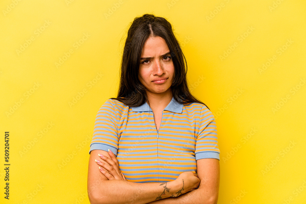 Fototapeta premium Young hispanic woman isolated on yellow background unhappy looking in camera with sarcastic expression.