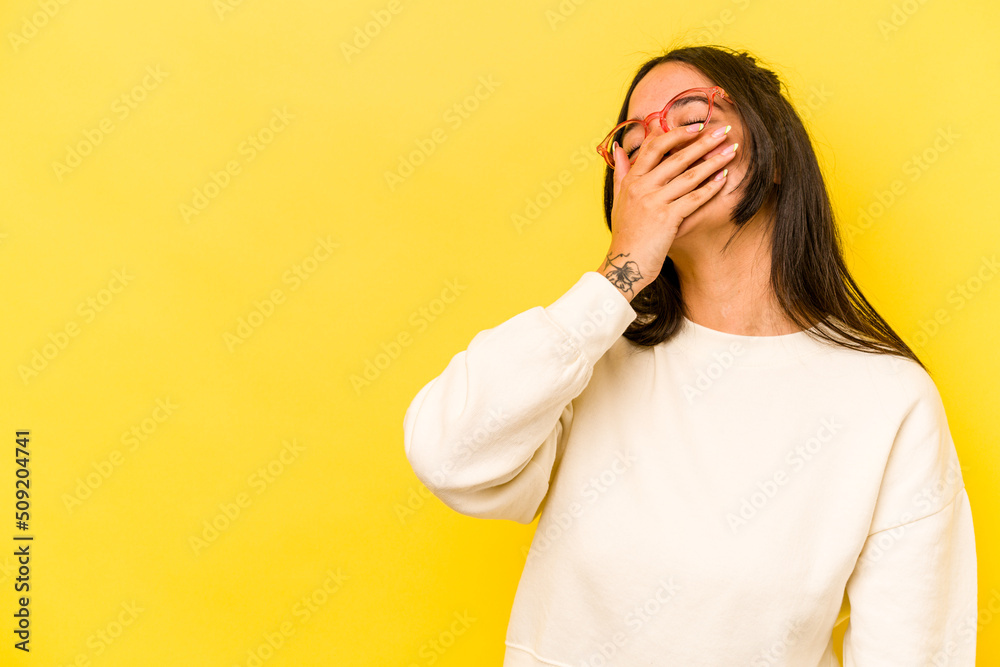Young hispanic woman isolated on yellow background laughing happy, carefree, natural emotion. Young hispanic woman isolated on yellow background laughing happy, carefree, natural emotion.