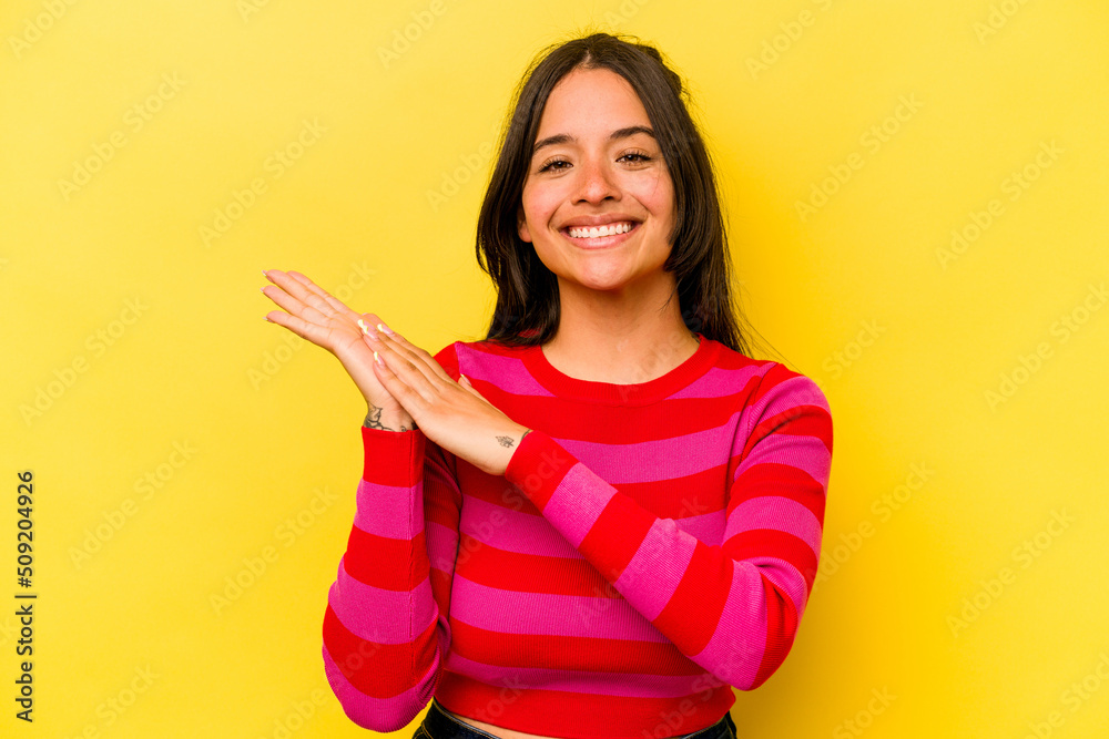 Young hispanic woman isolated on yellow background feeling energetic and comfortable, rubbing hands confident. Young hispanic woman isolated on yellow background feeling energetic and comfortable, rubbing hands confident.