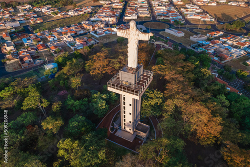 Sertaozinho, São Paulo / Brazil - Circa june 2022: Aerial image of the city of Sertaozinho, SP. Christ the Redeemer monument of the city, way of faith. photo