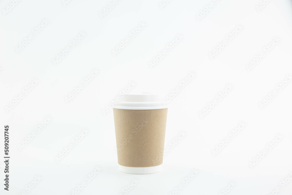 Brown paper coffee mugs with black lids placed on a white background.