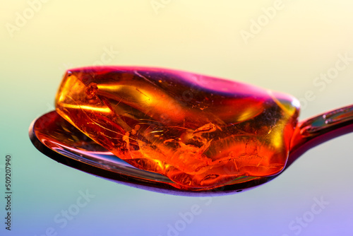 Amber made of yellow transparent fossil resin with insect inclusions photographed in the studio photo