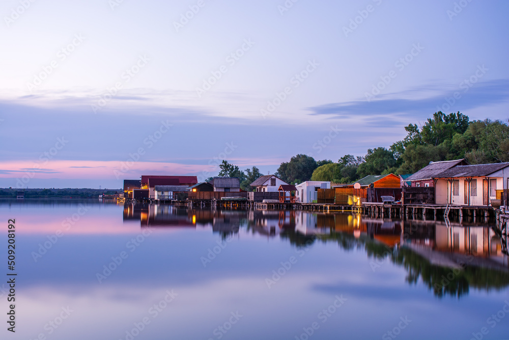 Floating village on Bokod lake in Hungary, dramatic sunset sky Floating village on Bokod lake in Hungary, dramatic sunset sky