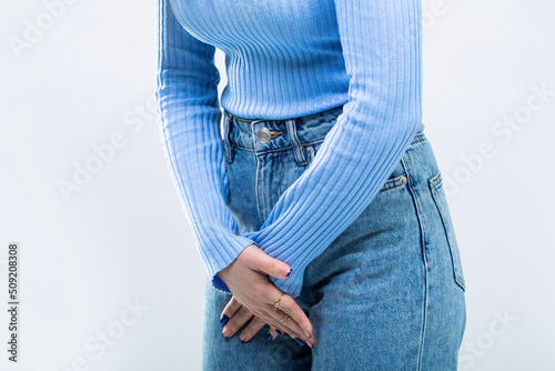 Medical or gynecological problems, healthcare concept. Close up of a woman with hands holding her crotch. Woman Hands Holding Her Crotch. Sick woman hands holding pressing her crotch lower abdomen