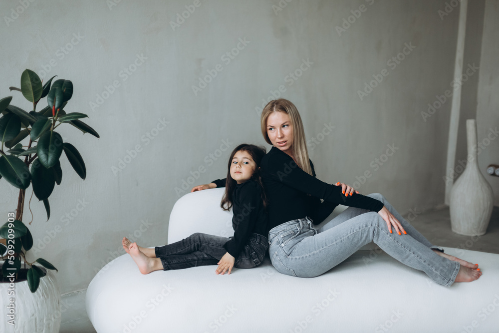 Happy family mother and daughter together have fun and huggingf at home Happy family mother and daughter together have fun and huggingf at home