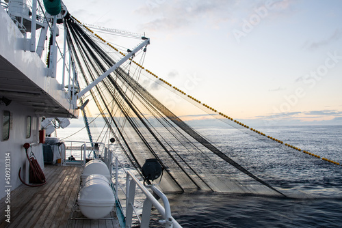 Stampa su tela Fishing boat fishing for tuna fish during sunrise