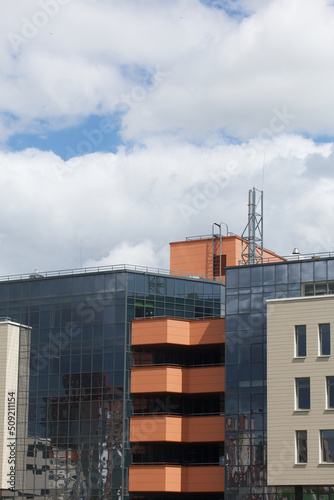 Modern building in glass and concrete. Against the background of the blue sky.