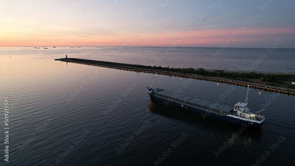 Cargo ship on the background of the fiery sunset of the Baltic Sea. Cargo ship on the background of the fiery sunset of the Baltic Sea.