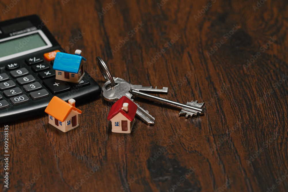 Toy house keys and calculator. Real estate purchase concept. Toy house keys and calculator. Real estate purchase concept.